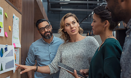 A woman instructing a group of employees